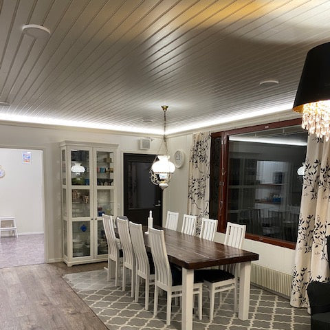 Dining room with wooden table and chairs on a patterned rug
